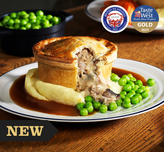 Whitbread Inns Chicken and Mushroom Pie with peas, gravy and mashed potato on a plate next to a silver knife and fork.